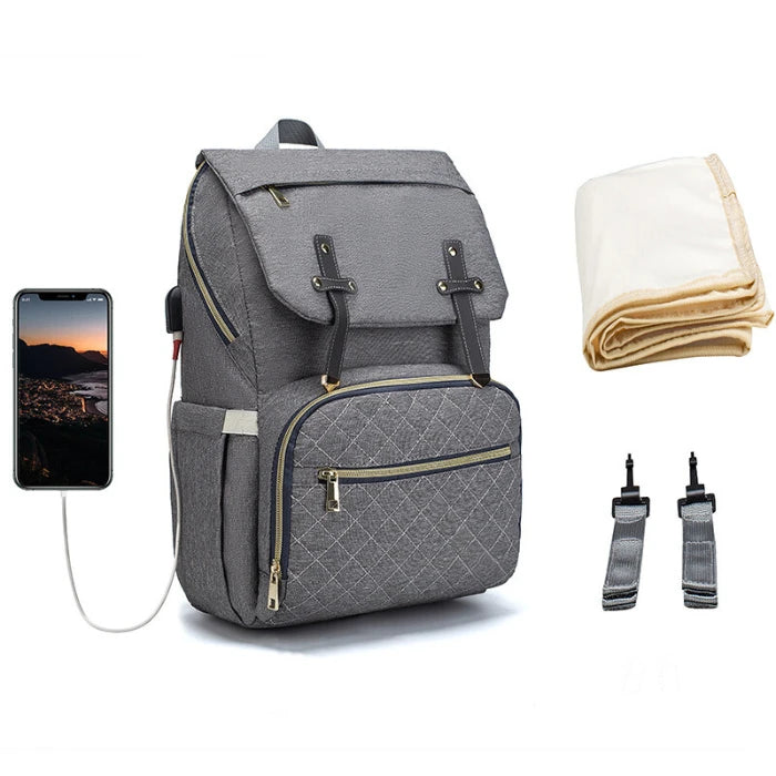 Premium grey quilted diaper backpack featuring USB charging port, stroller clips and insulated storage for modern families