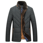 Quilted insulated jacket in dark green featuring a plush collar and detailed stitching.