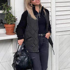 Quilted jacket featuring black diamond quilting and textured knit sleeves, offering sleek warmth for modern urban layering