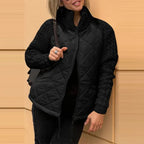 Quilted jacket with black quilted front, knit sleeves and zip closure, delivering flexible comfort for day to night wear