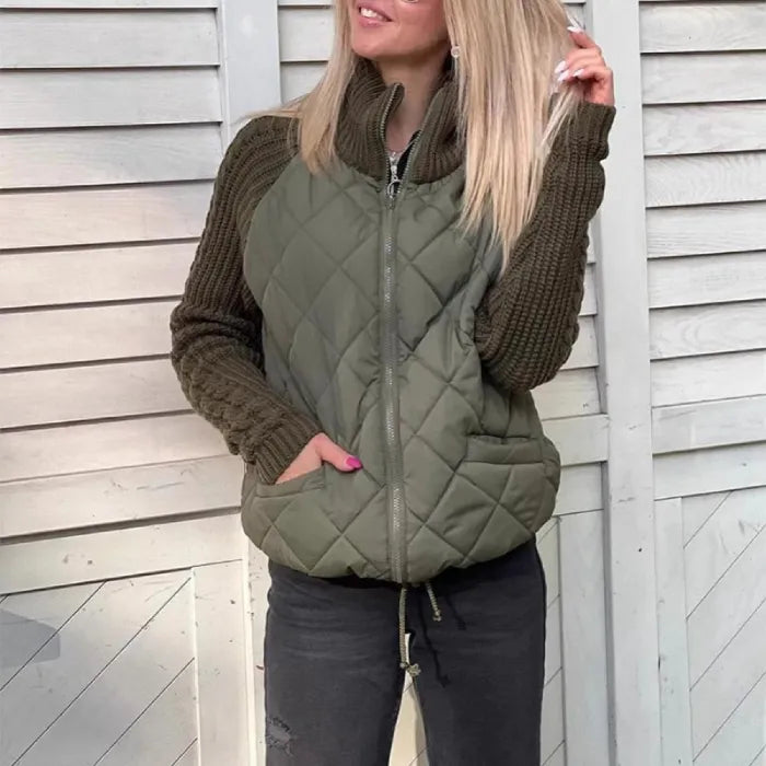 Quilted jacket with olive quilted body and chunky knit sleeves, zip front and pockets, offering cozy warmth and everyday comfort