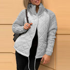 Quilted jacket in light gray with soft quilted texture and knit sleeves, providing breathable warmth and effortless style