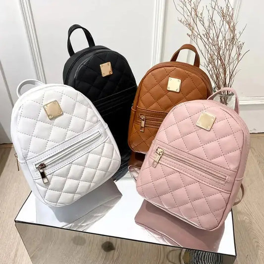 Stylish quilted mini backpacks in white, black, brown, and pink with gold metal accents and front zipper pockets