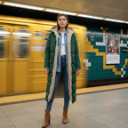 quilted puffer coat in green worn on subway platform, long women’s winter outerwear built for cold commutes