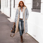 quilted puffer coat in light gray worn outdoors, long insulated women’s winter coat with modern fit