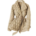 Quilted puffer jacket beige color with soft quilt texture and belted waist, offering warm stylish winter coat appeal for shoppers