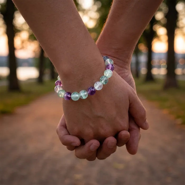 Rainbow Fluorite Crystal Bracelet worn by couple holding hands outdoors, symbolizing emotional balance connection and loving energy