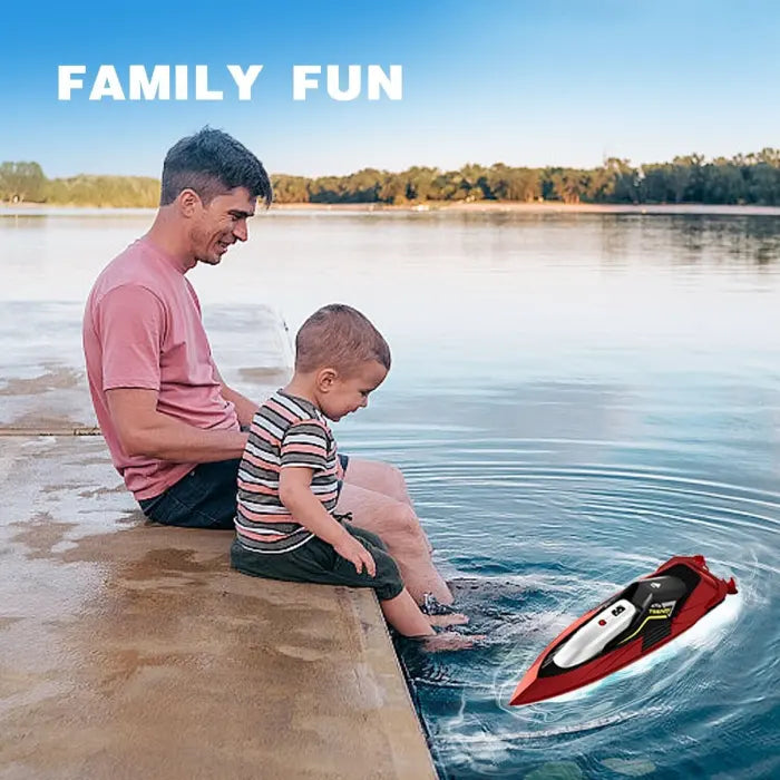 RC speed boat floating near father and son enjoying lakeside family fun moment together.
