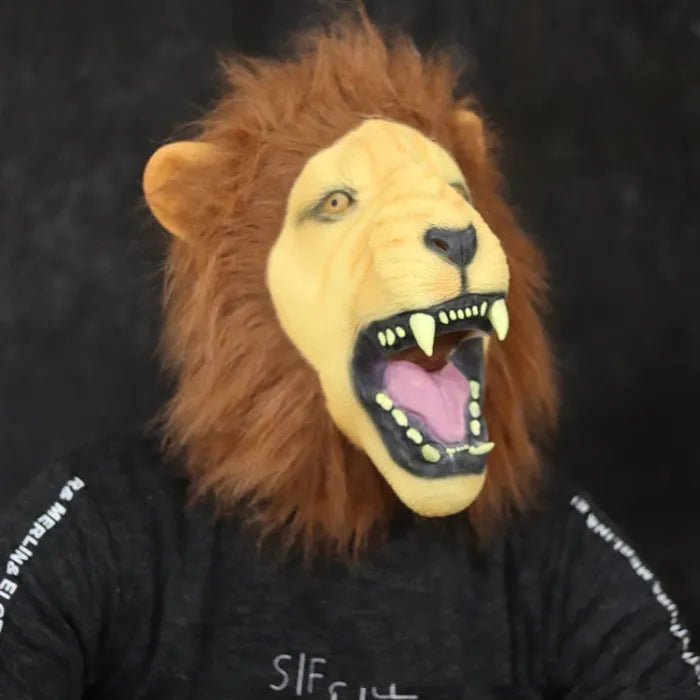 Brown-maned adult lion mask with open mouth and sharp fangs on black background.