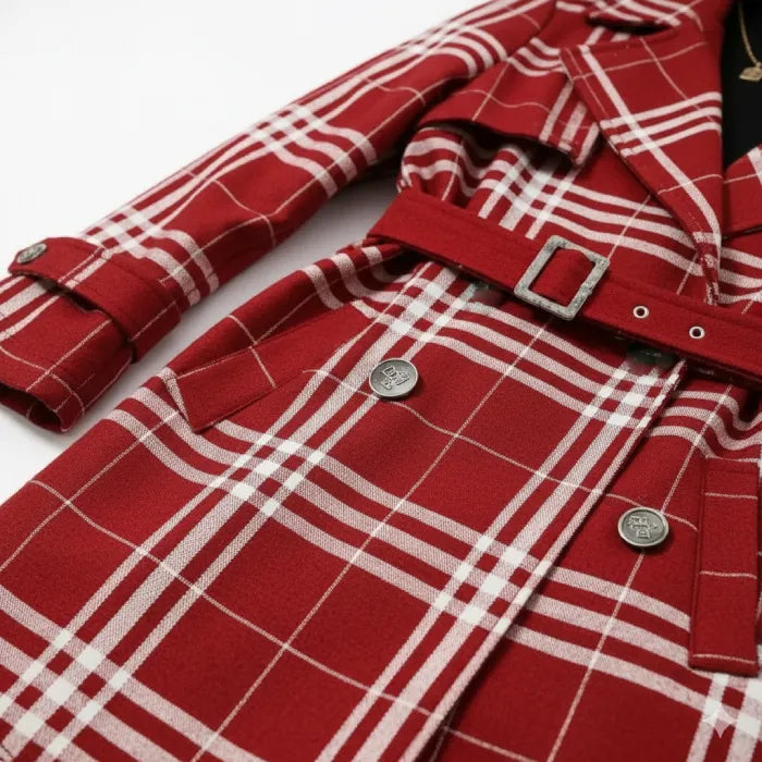 Red belted trench close up showing plaid fabric texture, double buttons, and belt hardware for premium winter style.