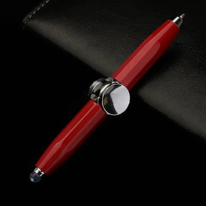 Red fidget spinner pen with stylus tips and chrome accents, displayed on black leather.