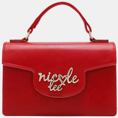 Front view of red leather handbag featuring silver logo design, flap closure, and structured shape