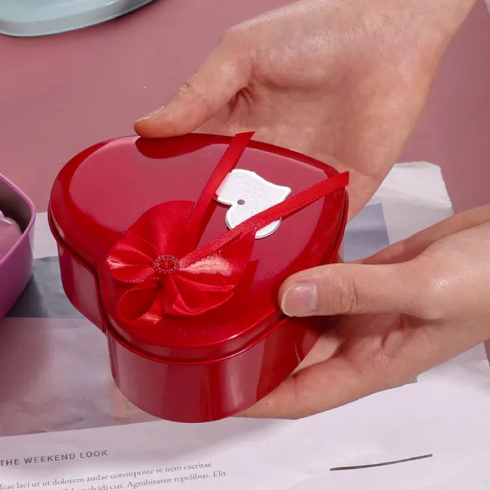 Red metallic heart box with satin bow and love message tag for romantic gifting