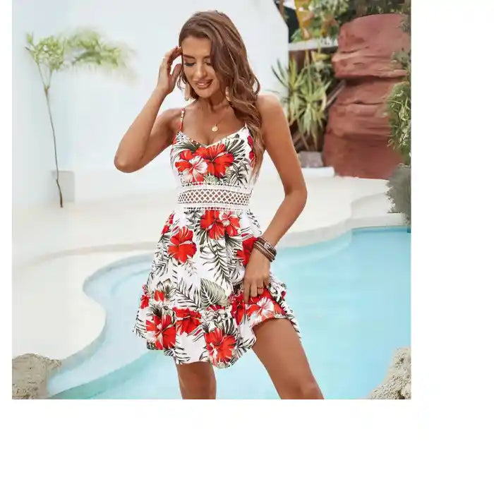 red hibiscus spaghetti strap dress twirling in breezy motion by the pool with tropical décor and greenery