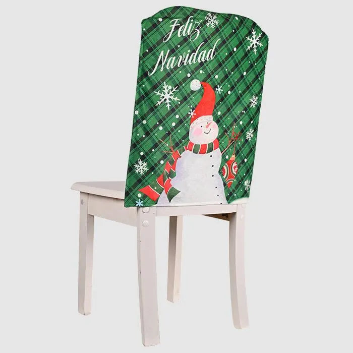 Festive dining chairs with red and green plaid Christmas covers featuring Santa and snowman designs, set against holiday decor