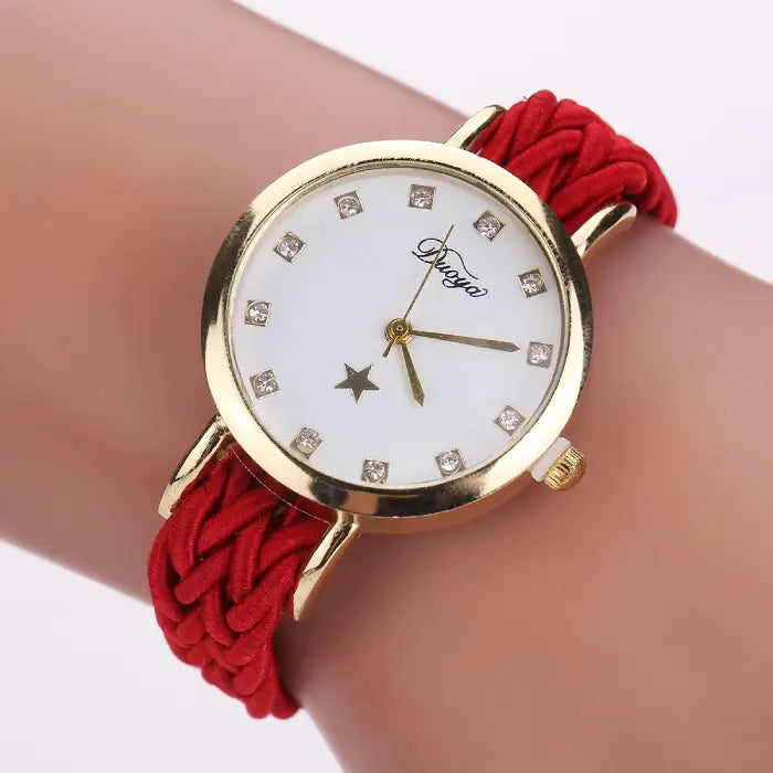 Women's watch with a gold case, white dial, and red braided rope band.