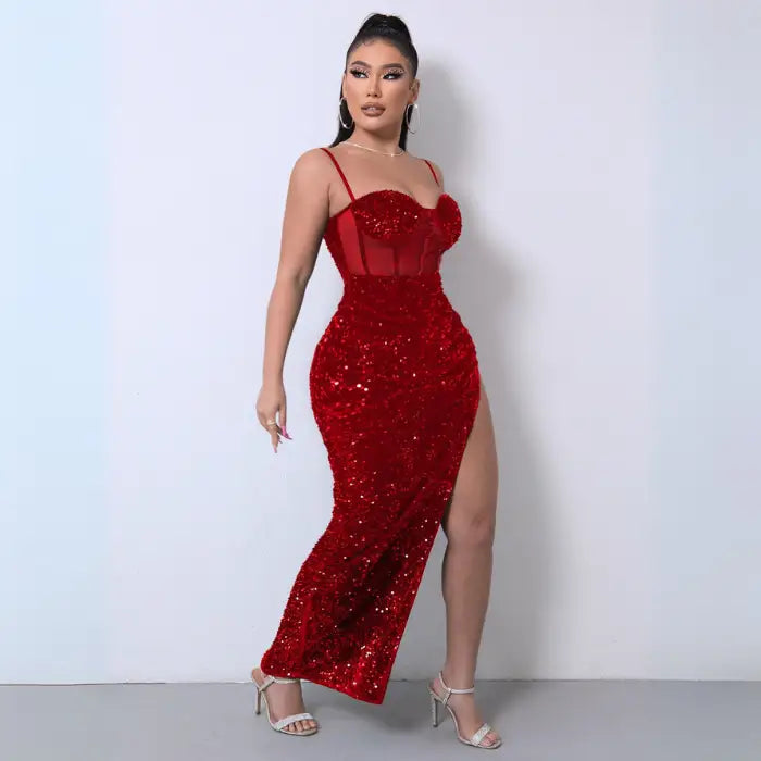 Red sequin spliced mesh dress with a thigh-high slit, sheer corset bodice, and spaghetti straps.
