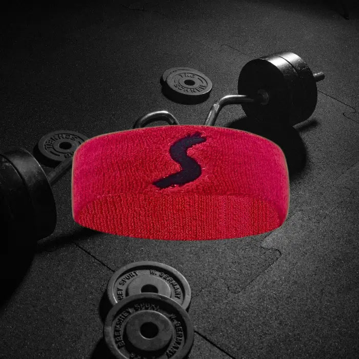 red sweatband with a black logo, ideal for sports and fitness activities to absorb sweat effectively.