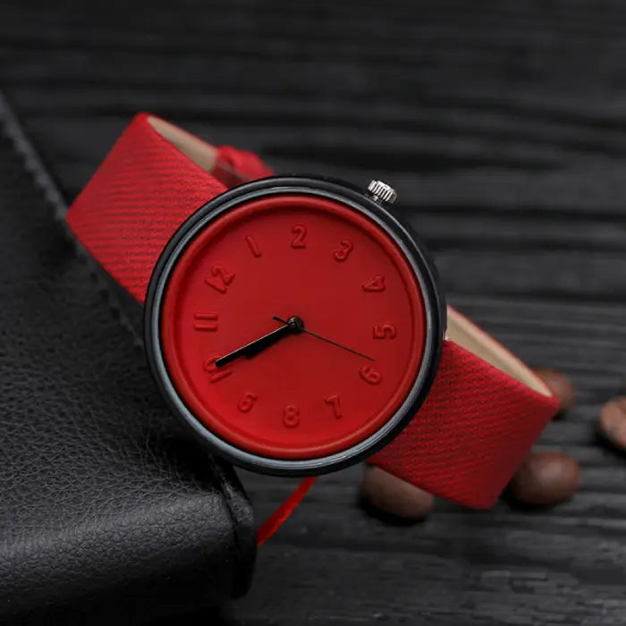 Red minimalist wristwatch with textured strap and bold design for trendy and versatile accessories.