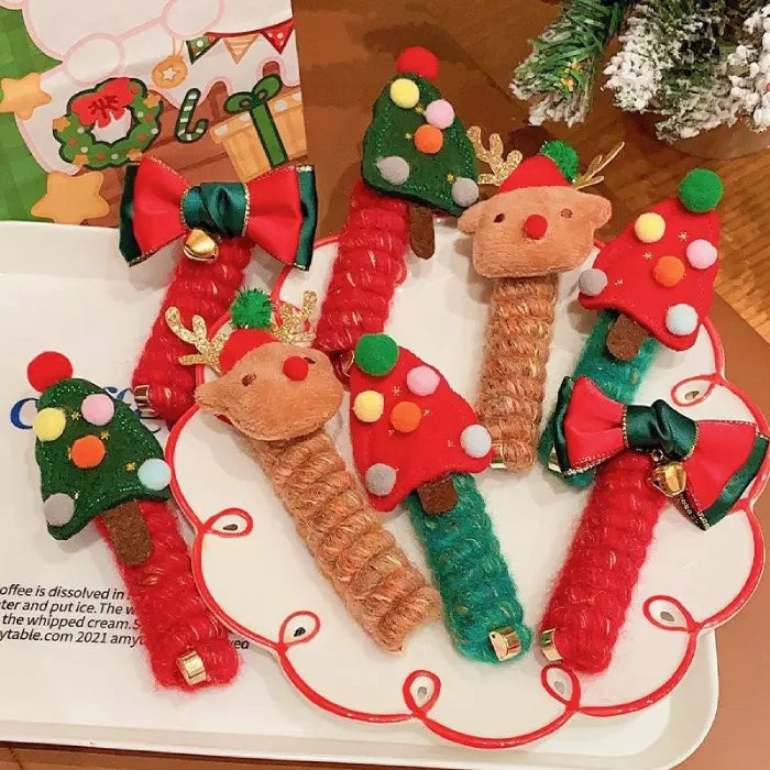 Close-up of reindeer-themed Christmas hair rope with gold antlers and festive red hat.