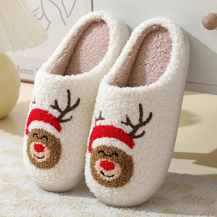 Cozy Christmas slippers featuring a reindeer design with a red nose and festive details.