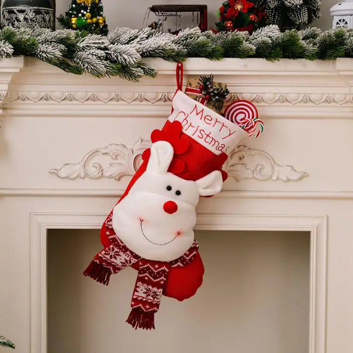 Reindeer-themed Christmas stocking hanging on white fireplace mantel with holiday greenery garland