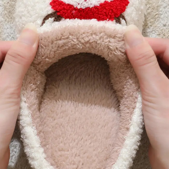 Close-up view of the interior plush lining of reindeer-themed Christmas slippers.