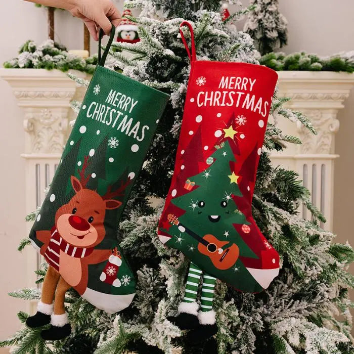 Reindeer and tree-themed Christmas stockings hanging on a frosted tree, perfect for festive decor.