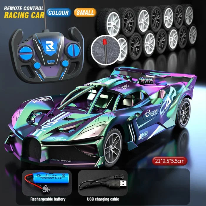 Compact iridescent remote control racing car, matching controller, spare wheels, rechargeable battery, and USB charging cable.