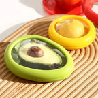 reusable avocado and lemon storage containers displayed on bamboo cutting board showing fresh produce preservation
