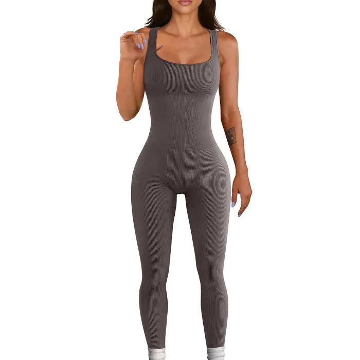 Woman wearing a grey ribbed knit jumpsuit with a fitted, seamless design
