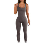 Woman wearing a grey ribbed knit jumpsuit with a fitted, seamless design