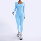 Ribbed knit jumpsuit in light blue shown in a walking pose, highlighting a smooth stretch one-piece outfit designed for chic active daily style