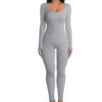 Ribbed knit jumpsuit in light grey displayed in a clear product pose, showcasing a smooth one-piece outfit perfect for modern minimal looks