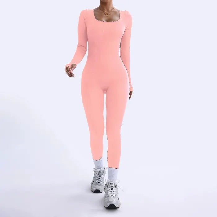 Ribbed knit jumpsuit in soft peach shown in a walking pose, highlighting a flattering one-piece outfit ideal for bright feminine styling