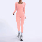 Ribbed knit jumpsuit in soft peach shown in a walking pose, highlighting a flattering one-piece outfit ideal for bright feminine styling