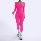 Ribbed knit jumpsuit in bold hot pink shown mid-stride, featuring a fun stretch one-piece outfit perfect for energetic, expressive styling