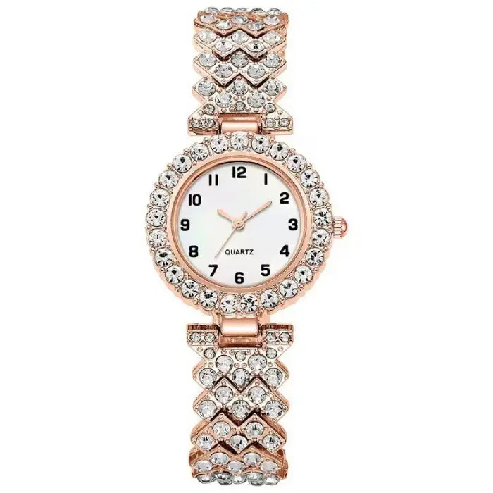 Rose gold quartz wristwatch with a white face and a chevron-patterned diamond like-studded band.