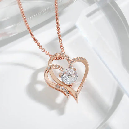 Rose gold plated heart-shaped necklace with sparkling stones, displayed in a delicate and stylish close-up.