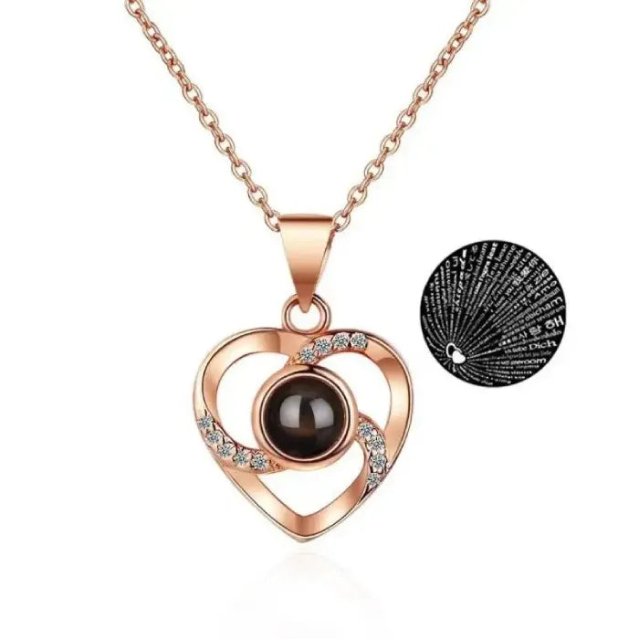 Rose gold heart pendant with sparkling stones, projects 100 languages.