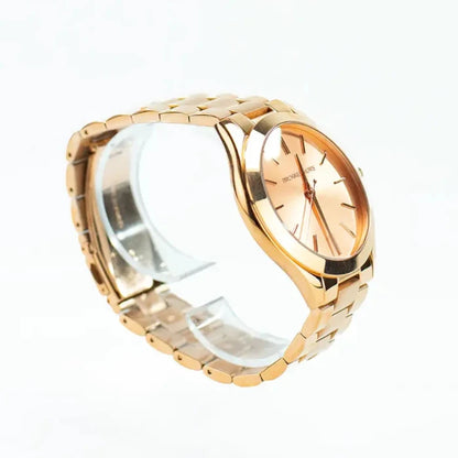 Side angle view of rose gold Michael Kors watch showing linked bracelet band and minimalist dial design