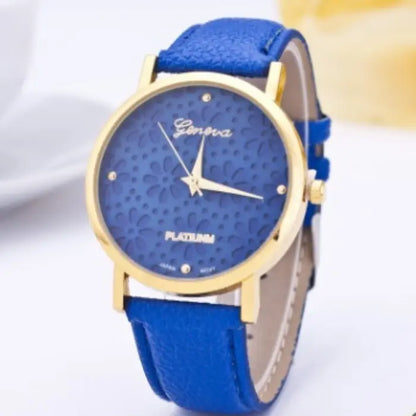 Royal blue women's watch with a gold floral-patterned dial and royal blue leather strap.