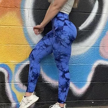 Royal blue tie-dye compression leggings against colorful graffiti wall with scrunch detail