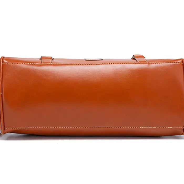 Satchel handbag bottom view in smooth brown leather with structured base
