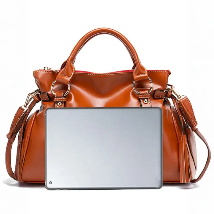 Satchel handbag in brown leather shown fitting a full-size tablet or small laptop
