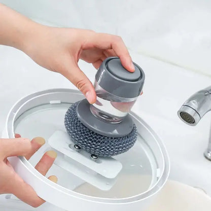 Soap-dispensing scrubber used for cleaning glass lids with an ergonomic and efficient design.