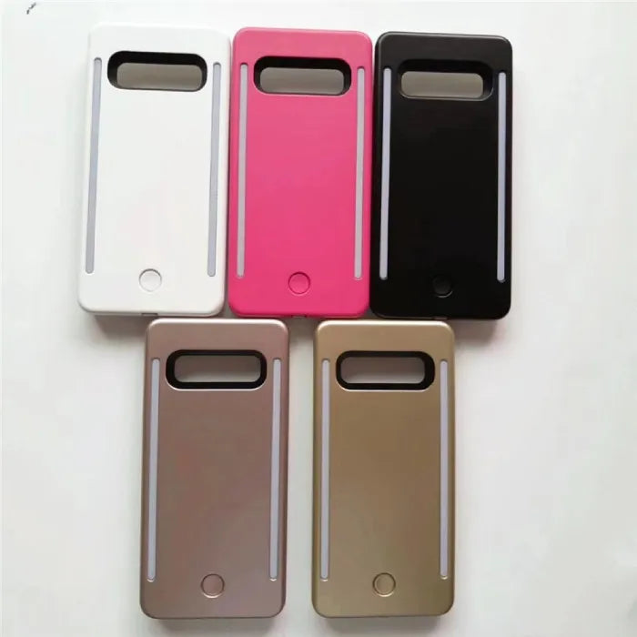 Collection of selfie cases in white, pink, black, bronze, and gold with vertical LED strips.