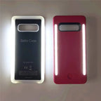 Selfie case in glowing white and pink colors, showing bright LED light strips turned on.