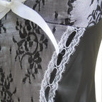Sexy Maid Halloween Costume lace and ribbon detail in close-up of black floral mesh bodice.