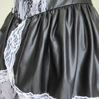 Sexy Maid Halloween Costume faux leather skirt close-up with white lace trim and black gloss finish.